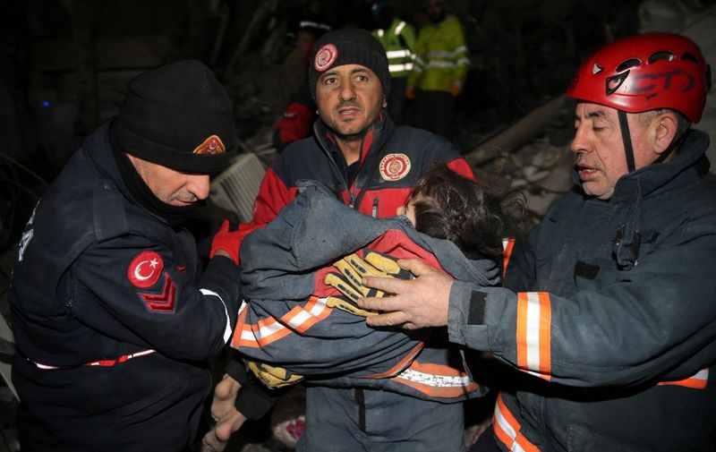 KAHRAMANMARAS, TURKIYE - FEBRUARY 09: 5-year-old Mir Berzan Bagis, along with her mother and father rescued by search and rescue teams from under rubble of a collapsed building 73 hours after 7.7 and 7.6 magnitude earthquakes hit Turkiye's Kahramanmaras, on February 09, 2023. Health condition of 5-year-old girl, Mir Berzan Bagis was reported to be stable, and the family of 3 transferred to a hospital. Early Monday morning, a strong 7.7 earthquake, centered in the Pazarcik district, jolted Kahramanmaras and strongly shook several provinces, including Gaziantep, Sanliurfa, Diyarbakir, Adana, Adiyaman, Malatya, Osmaniye, Hatay, and Kilis. Later, at 13.24 p.m. (1024GMT), a 7.6 magnitude quake centered in Kahramanmaras' Elbistan district struck the region. Turkiye declared 7 days of national mourning on Feb. 06 after deadly earthquakes in southern provinces. Serhat Zafer / Anadolu Agency (Photo by Serhat Zafer / ANADOLU AGENCY / Anadolu Agency via AFP)