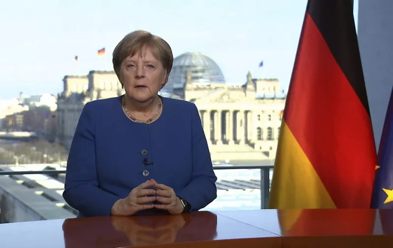 This videograb taken from German TV channel ARD on March 18, 2020 shows German Chancellor Angela Merkel addressing the nation on the spread of the new coronavirus COVID-19 at the Chancellery, with a view in the background of the Reichstag, the building housing the lower house of parliament. - Germany is facing its biggest challenge "since the Second World War" in the fight against the coronavirus pandemic, Chancellor Angela Merkel said in a television address urging citizens to heed sweeping confinement measures. (Photo by Uta TOCHTERMANN / AFP)