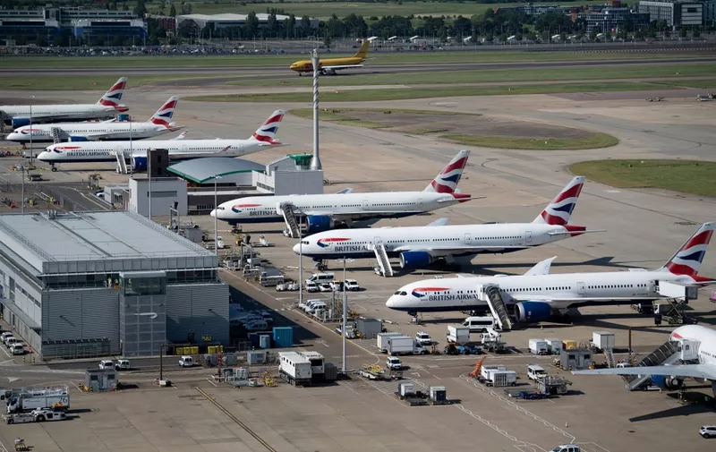 British Airways jets are seen at Heathrow Airport June 13, 2021, in west London. (Photo by Brendan Smialowski / AFP)