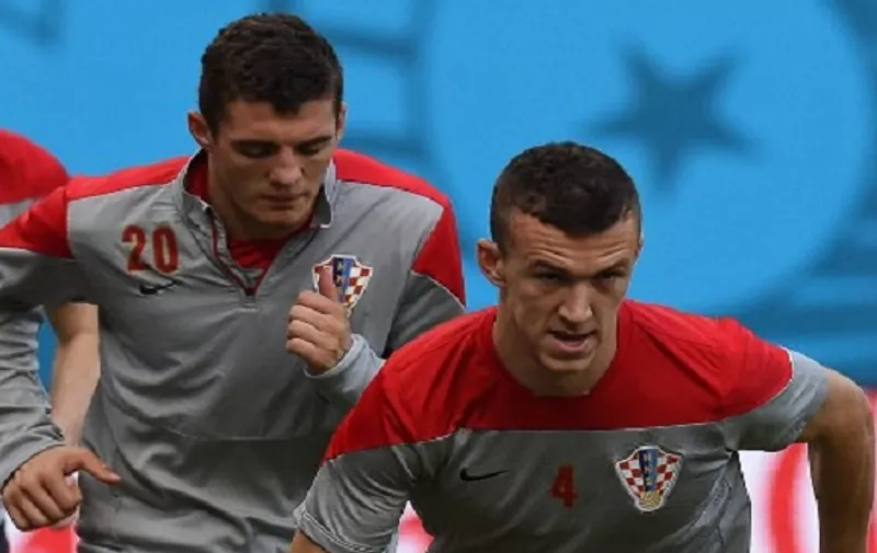 Croatia's midfielder Mateo Kovacic (L) and Croatia's midfielder Ivan Perisic run during a training session at Pernambuco Arena in Recife on June 22, 2014, on the eve of the 2014 FIFA World Cup Group A football match between Croatia and Mexico.   AFP PHOTO/ DIMITAR DILKOFF