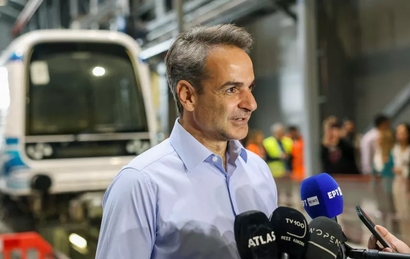 New Democracy party leader and Greek Prime Minister Kyriakos Mitsotakis, 55-years-old, speaks to the press inside the  Thessaloniki subway during its trial run with passengers in Thessaloniki, northern Greece, on May 18, 2023, ahead of Greece's general elections scheduled for May 21. (Photo by ALEXANDROS AVRAMIDIS / POOL / AFP)
