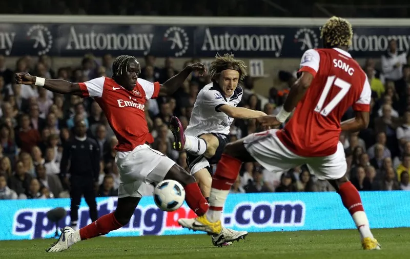 Tottenham Hotspurs' Croatian player Luka Modric (C) shoots at goal past Arsenal's French defender Bacary Sagna (L) and Alex Song (R) during the Premiership football match at White Hart Lane in London on April 20, 2011. AFP PHOTO/ ADRIAN DENNIS

FOR EDITORIAL USE ONLY Additional licence required for any commercial/promotional use or use on TV or internet (except identical online version of newspaper) of Premier League/Football League photos. Tel DataCo +44 207 2981656. Do not alter/modify photo.