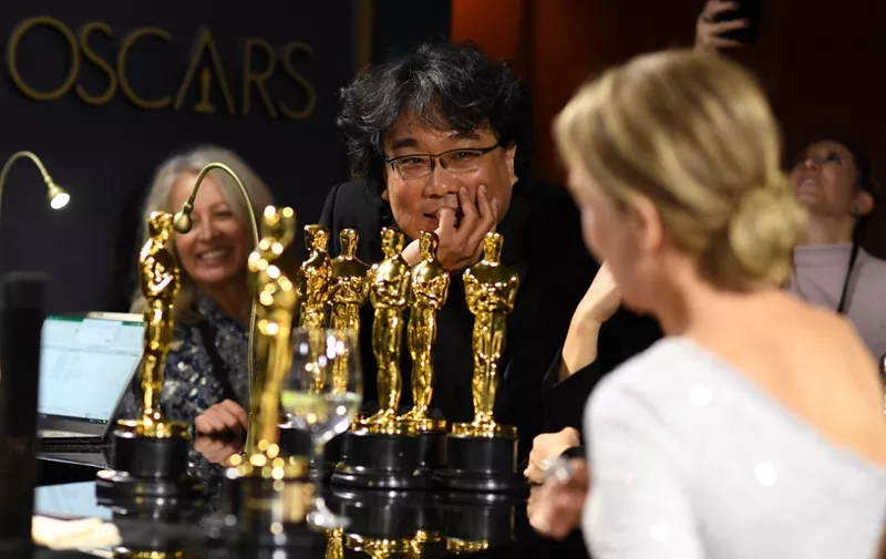 South Korean film director Bong Joon Ho (L) and US actress Renee Zellweger (R) wait for their awards to be engraved as they attend the 92nd Oscars Governors Ball at the Hollywood &amp; Highland Center in Hollywood, California on February 9, 2020. (Photo by VALERIE MACON / AFP)