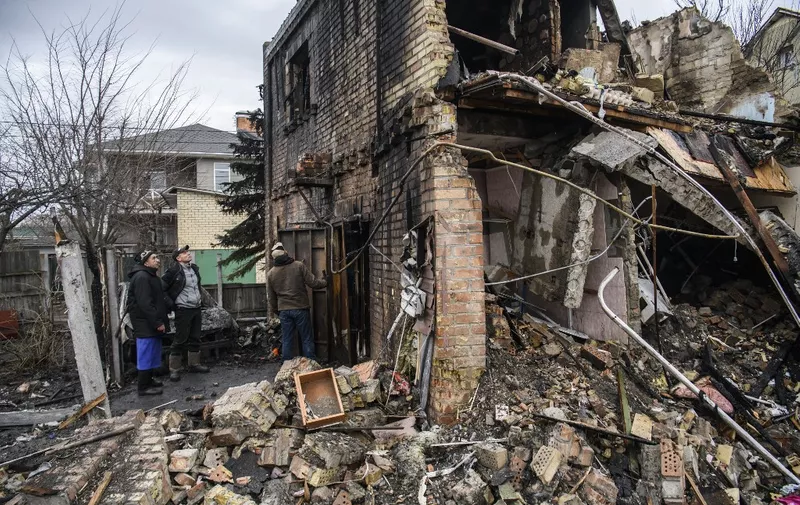 Local residents are removing the remnants of the residential house destroyed during massive Russian missile strike today early morning in Kyiv, Ukraine December 29, 2022 (Photo by Maxym Marusenko/NurPhoto) (Photo by Maxym Marusenko / NurPhoto / NurPhoto via AFP)