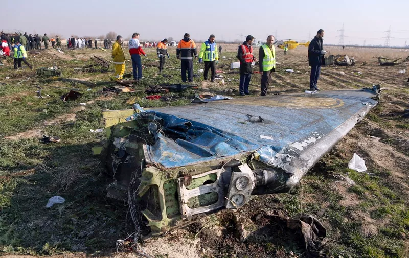 Rescue teams are seen on January 8, 2020 at the scene of a Ukrainian airliner that crashed shortly after take-off near Imam Khomeini airport in the Iranian capital Tehran. - Search-and-rescue teams were combing through the smoking wreckage of the Boeing 737 flight from Tehran to Kiev but officials said there was no hope of finding anyone alive. The vast majority of the passengers on the Ukraine International Airlines flight were non-Ukrainians, including 82 Iranians and 63 Canadians, officials said. (Photo by Akbar TAVAKOLI / IRNA / AFP)