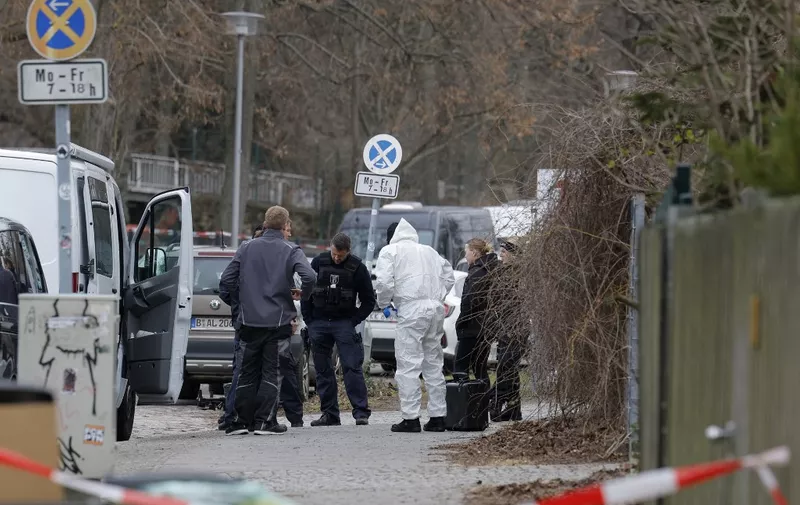 Police and a forensic investigator are seen behind a cordoned-off perimeter near the 'Buergerpark' in the northern district of Pankow of Berlin, Germany on February 22, 2023, one day after the dead body of a 5-year-old girl, who had previously been reported missing, was found by a passer-by. According to the police, after the girl was found, attempts were made to resuscitate her, but without success. A 19-year-old suspect who is said to come from the child's environment has already been arrested. (Photo by Odd ANDERSEN / AFP)