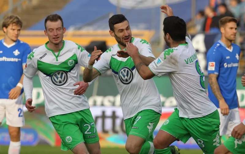 Wolfsburg's midfielder Daniel Caligiuri (C) celebrates scoring with his team-mates during the German first division Bundesliga football match SV Darmstadt 98 vs VfL Wolfsburg in Darmstadt, western Germany, on October 24, 2015. AFP PHOTO / DANIEL ROLAND

RESTRICTIONS: DURING MATCH TIME: DFL RULES TO LIMIT THE ONLINE USAGE TO 15 PICTURES PER MATCH AND FORBID THE IMAGE SEQUENCES TO SIMULATE VIDEO.
== RESTRICTED TO EDITORIAL USE == 
FOR FURTHER QUERIES PLEASE CONTACT DFL DIRECTLY AT + 49 69 650050.