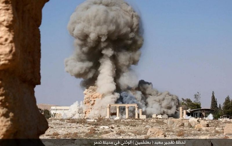 An undated image, which appears to be a screenshot from a video and which was published by the Islamic State group in the Homs province (Welayat Homs) on August 25, 2015, allegedly shows smoke billowing from the Baal Shamin temple in Syria's ancient city of Palmyra. The temple was reportedly destroyed by the extremist group and news of its demolition sparked international condemnation earlier this week. AFP PHOTO / HO / WELAYAT HOMS 
=== RESTRICTED TO EDITORIAL USE - MANDATORY CREDIT "AFP PHOTO / HO / WELAYAT HOMS" - NO MARKETING NO ADVERTISING CAMPAIGNS - DISTRIBUTED AS A SERVICE TO CLIENTS FROM ALTERNATIVE SOURCES, AFP IS NOT RESPONSIBLE FOR ANY DIGITAL ALTERATIONS TO THE PICTURE'S EDITORIAL CONTENT, DATE AND LOCATION WHICH CANNOT BE INDEPENDENTLY VERIFIED ===