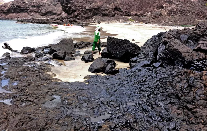 An oil contaminated beach is pictured after a tanker sank off the coast of Yemen's southern port city of Aden on July 21, 2021. (Photo by Saleh OBAIDI / AFP)