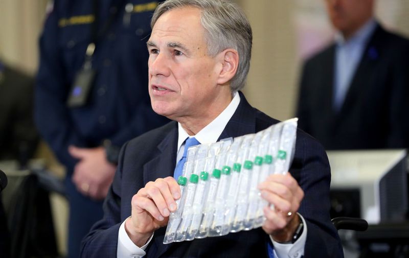 ARLINGTON, TEXAS - MARCH 18: Texas Governor Greg Abbott displays COVID-19 test collection vials as he addresses the media during a press conference held at Arlington Emergency Management on March 18, 2020 in Arlington, Texas. Abbott announced that Arlington health officials received 2,500 testing kits so all residents and workers at the Texas Masonic Retirement Home, the retirement home where COVID-19 victim Patrick James lived with his wife, will be tested for the virus. (Photo by Tom Pennington/Getty Images)