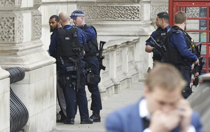 Firearms officiers from the British police detain a man on Whitehall near the Houses of Parliament in central London on April 27, 2017 before being taken away by police. 
Metropolitan police attended an incident on Whitehall in central London near the Houses of Parliament where one man was arrested, police said. / AFP PHOTO / Niklas HALLE'N