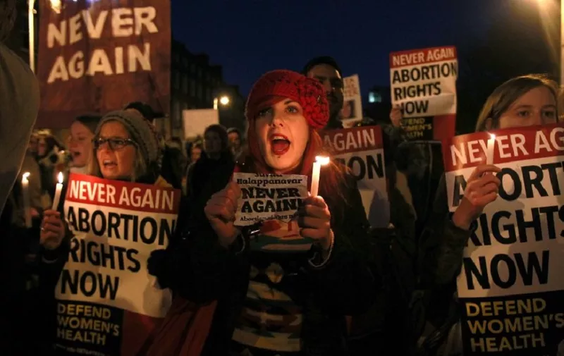 Demonstrators hold placards and candels in memory of Indian Savita Halappanavar in support of legislative change on abortion during a march from the Garden of Remembrance to the Dail (Irish Parliament) in Dublin, Ireland on November 17, 2012.  Ireland's tough abortion laws came under fire following the death of the Indian woman Halappanavar after doctors allegedly refused her a termination because it was against the laws of the Catholic country.  The Indian woman, who was 17 weeks pregnant, repeatedly asked the hospital to terminate her pregnancy because she had severe back pain and was miscarrying, her family said. AFP PHOTO / PETER MUHLY / AFP PHOTO / PETER MUHLY