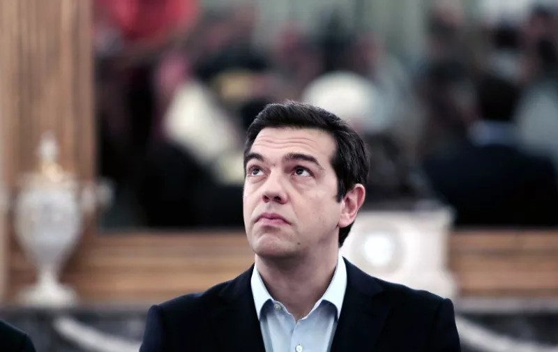 (FILES)- A July 18, 2015 file photo shows Greek Prime Minister Alexis Tsipras looking up during a swearing-in ceremony of the newly appointed members of the Government at the Presidential Palace in Athens. Tsipras announced his resignation and called for early elections in the crisis-hit country on August 20, 2015.AFP PHOTO / ANGELOS TZORTZINIS