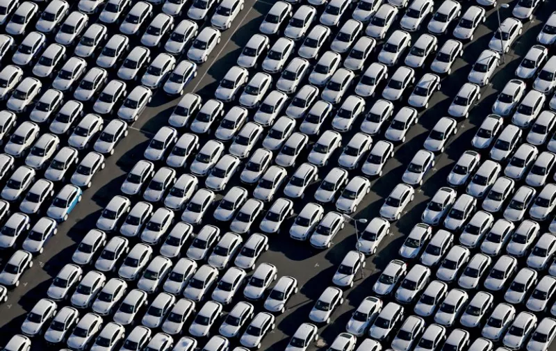 New Porsche cars are parked at the grounds of the Porsche plant in Leipzig, eastern Germany, on November 3, 2015. The US Environmental Protection Agency said late Monday, November 2, 2015, it had discovered that various six-cylinder 3.0 litre diesel VW Touareg, Porsche Cayenne and Audis were also rigged with a software which skews the results of pollution tests.     AFP PHOTO / DPA / JAN WOITAS   +++   GERMANY OUT   +++
