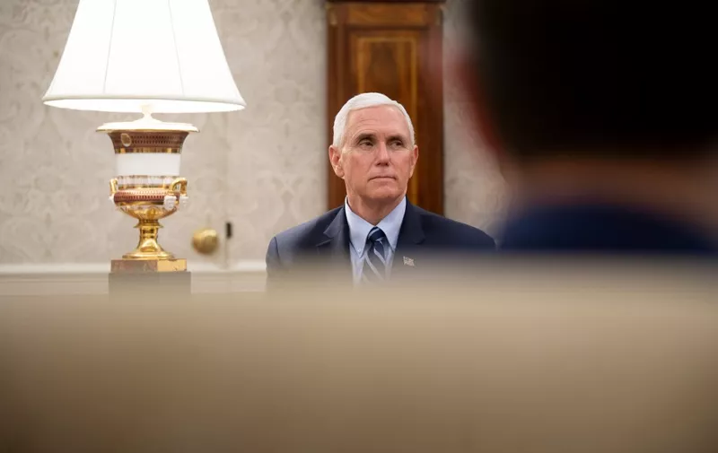 US Vice President Mike Pence listens as Texas's Governor Greg Abbott and US President Donald Trump speak to the press after a meeting in the Oval Office of the White House May 7, 2020, in Washington, DC. (Photo by Brendan Smialowski / AFP)