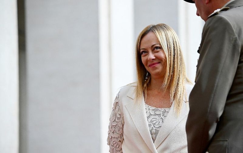 Italian Prime Minister Giorgia Meloni (L), smiles as she waits for Bahrain's King prior to their meeting at Palazzo Chigi in Rome on October 17, 2023. (Photo by Filippo MONTEFORTE / AFP)