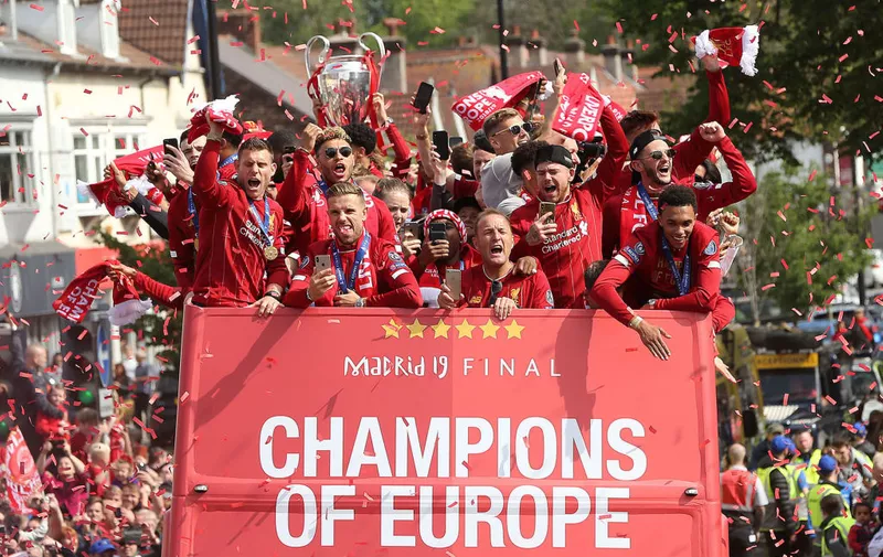 LIVERPOOL, ENGLAND &#8211; JUNE 02: (EDITOR&#8217;S NOTE: Alternative crop of image #1147564677) James Milner, Alex Oxlade-Chamberlain, Jordan Henderson, Alberto Moreno, Adam Lallana and Trent Alexander-Arnold of Liverpool with the UEFA Champions League trophy on board a parade bus after winning the UEFA Champions League final against Tottenham Hotspur in Madrid on June 2, 2019 in [&hellip;]