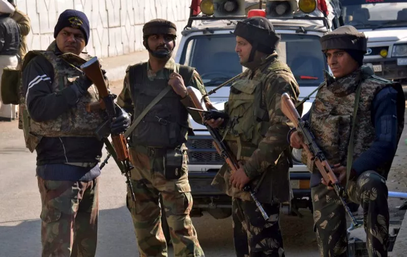 Indian security personnel stand alert on a road leading to an airforce base in Pathankot on January 2, 2016, during an ongoing attack on the base in the northern Indian state of Punjab by suspected militants.  Suspected Islamist gunmen have staged a pre-dawn attack on a key Indian air base near the Pakistan border with two militants killed in a shootout, officials said, striking a blow to the neighbours' fragile peace process. AFP PHOTO/NARINDER NANU / AFP / NARINDER NANU