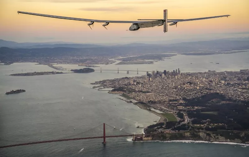 This handout photo taken on April 23, 2016 and released by Solar Impulse 2 shows "Solar Impulse 2", a solar-powered plane piloted by Swiss adventurer Bertrand Piccard, flying over the Golden Gate bridge and the downtown area in San Francisco, California.
Solar Impulse 2, an experimental plane flying around the world without consuming a drop of fuel, landed in California, one leg closer to completing its trailblazing trip.
 / AFP PHOTO / Solar Impulse 2 / Jean Revillard / -----EDITORS NOTE --- RESTRICTED TO EDITORIAL USE - MANDATORY CREDIT "AFP PHOTO / Jean Revillard / Solar Impulse 2 / Global Newsroom" - NO MARKETING - NO ADVERTISING CAMPAIGNS - DISTRIBUTED AS A SERVICE TO CLIENTS - NO ARCHIVES