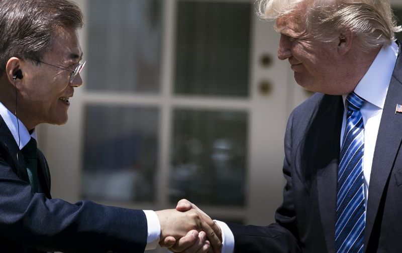 (FILES) This file photo taken on June 30, 2017 shows South Korea's President Moon Jae-in and US President Donald Trump shaking hands in the Rose Garden of the White House in Washington, DC.
Trump and Moon agreed on September 4, 2017, to remove limits on the payload of the South's missiles, Seoul's presidential office said, as the UN Security Council met to discuss a response to Pyongyang's sixth and most powerful nuclear test. The two leaders in a phone call "agreed to lift the cap on missile payload of South Korea as an effective countermeasure" against Pyongyang's test on Sunday. / AFP PHOTO / Brendan Smialowski