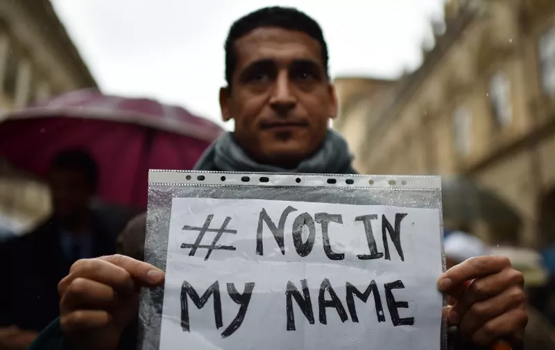 TOPSHOTS
A man shows a placard reading "Not In my Name" during a demonstration of muslims to speak out against terrorism a week after Paris attacks, on November 21, 2015 in Rome. Hundreds of Muslims rallied in Rome and Milan on Saturday to show solidarity with the victims of jihadist attacks, condemning violence in the name of religion and chanting "we are not the enemy". AFP PHOTO / GABRIEL BOUYS / AFP / GABRIEL BOUYS