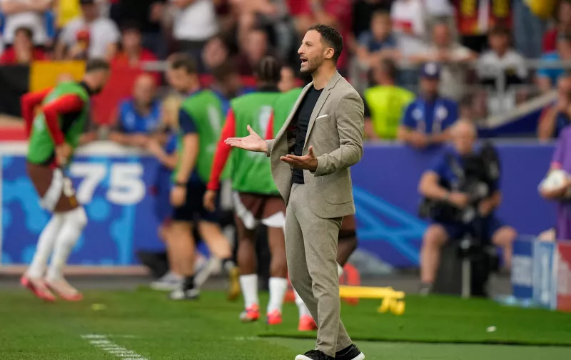 Belgium's head coach Domenico Tedesco shouts out as gives instructions from the side line during a Group E match between Ukraine and Belgium at the Euro 2024 soccer tournament in Stuttgart, Germany, Wednesday, June 26, 2024. (AP Photo/Matthias Schrader)