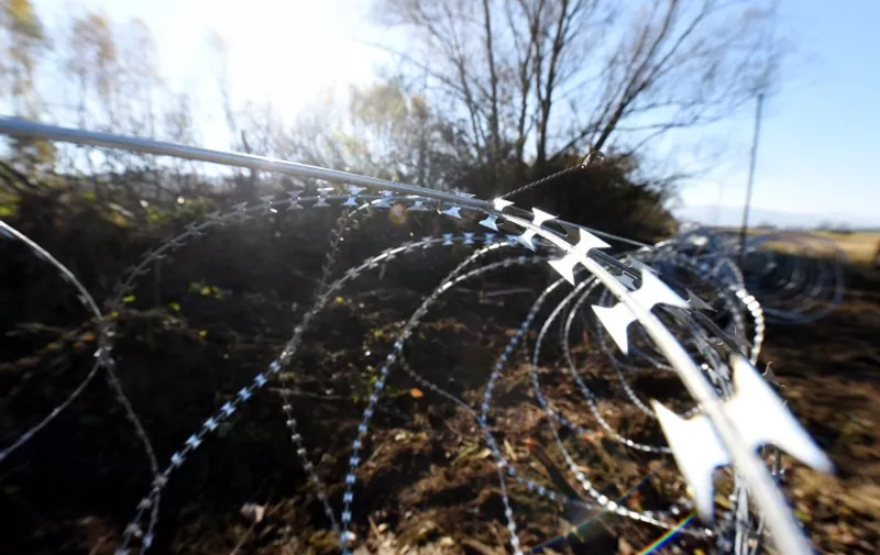 A photo taken on November 12, 2015 shows barbed wire fences set by Slovenian soldiers on the Slovenian-Croatian border near Rakovec. Slovenia found itself on the Balkans route taken by thousands of migrants heading to northern Europe after Hungary sealed its borders with Croatia and Serbia and began erecting razor wire along the border with fellow European Union member Croatia on November 11, in a move the government says will help it better manage a record influx of migrants. More than 180,000 passing have passed through the small EU member state of two million people since mid-October, all but a handful heading for Austria and beyond. AFP PHOTO / STRINGER