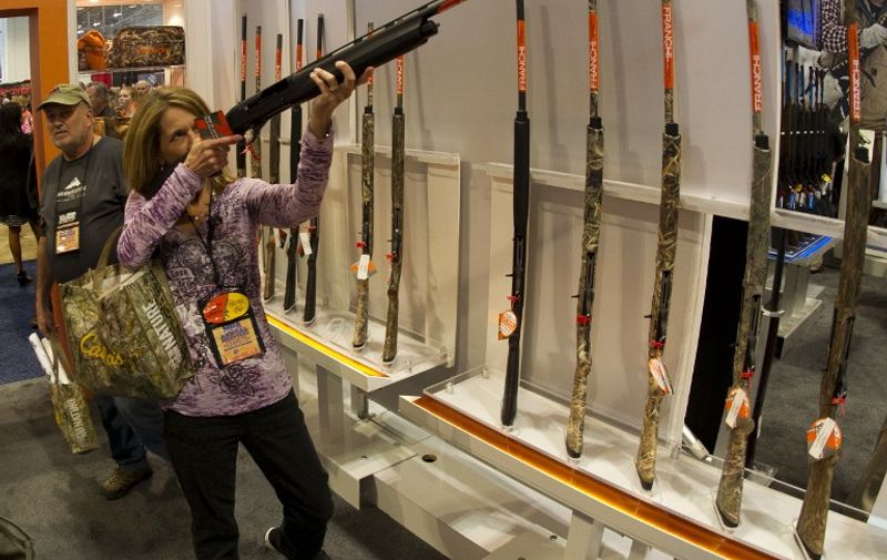 A woman aims a shotgun April 11, 2015 at the 2015 NRA Annual Convention in Nashville, Tennessee. AFP PHOTO / KAREN BLEIER