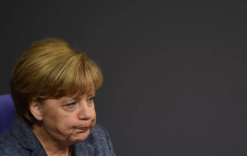 TOPSHOTS
German Chancellor Angela Merkel reacts during a debate ahead of a vote on a third bailout for debt-mired Greece at German lower house of parliament (the Bundestag) in Berlin on August 19, 2015.  AFP PHOTO / JOHN MACDOUGALL