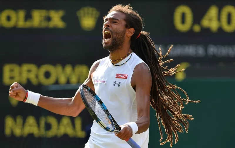Germany's Dustin Brown celebrates after winning the first set against Spain's Rafael Nadal during their men's singles second round match on day four of the 2015 Wimbledon Championships at The All England Tennis Club in Wimbledon, southwest London, on July 2, 2015.   RESTRICTED TO EDITORIAL USE  --   AFP PHOTO / GLYN KIRK
