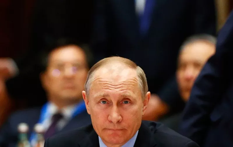Russia's President Vladimir Putin attends a summit at the Belt and Road Forum in Beijing on May 15, 2017.  
Chinese President Xi Jinping urged world leaders to reject protectionism on May 15 at a summit positioning Beijing as a champion of globalisation, as some countries raised concerns over his trade ambitions. / AFP PHOTO / POOL / THOMAS PETER