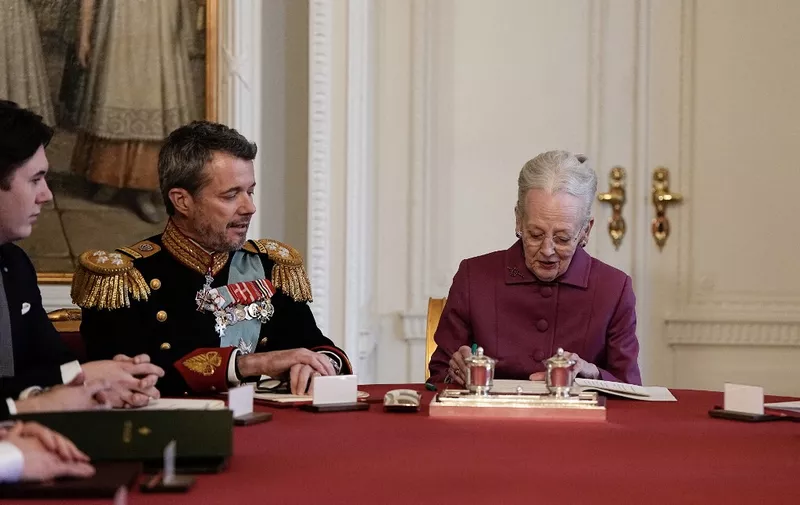 Queen Margrethe II of Denmark (R) signs a declaration of abdication as Crown Prince Frederik of Denmark (C) becomes King Frederik X of Denmark and Prince Christian of Denmark reacts in the Council of State at the Christiansborg Castle in Copenhagen, Denmark, on January 14, 2024. Denmark turns a page in its history on January 14 when Queen Margrethe abdicates and her son becomes King Frederik X, with more than 100,000 Danes expected to turn out for the unprecedented event.
The change of throne takes place during the meeting of the Council of State at the moment when the queen has signed a declaration of abdication. (Photo by Mads Claus Rasmussen / Ritzau Scanpix / AFP) / Denmark OUT