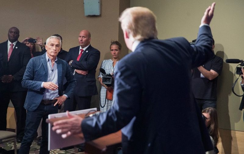 DUBUQUE, IA - AUGUST 25: Republican presidential candidate Donald Trump fields a question from Univision and Fusion anchor Jorge Ramos during a press conference held before his campaign event at the Grand River Center on August 25, 2015 in Dubuque, Iowa. Earlier in the press conference Trump had Ramos removed from the room when he failed to yield when Trump wanted to take a question from a different reporter. Trump leads most polls in the race for the Republican presidential nomination.   Scott Olson/Getty Images/AFP