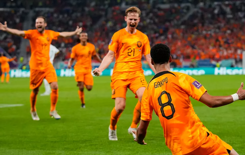 Cody Gakpo of the Netherlands, right, celebrates with teammates after scoring the opening goal during the World Cup, group A soccer match between Senegal and Netherlands at the Al Thumama Stadium in Doha, Qatar, Monday, Nov. 21, 2022. (AP Photo/Petr David Josek)