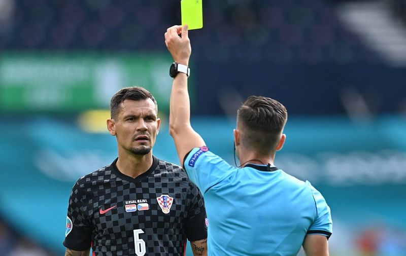 Spanish referee Carlos Del Cerro Grande (R) presents a yellow card to Croatia's defender Dejan Lovren during the UEFA EURO 2020 Group D football match between Croatia and Czech Republic at Hampden Park in Glasgow on June 18, 2021. (Photo by Paul ELLIS / POOL / AFP)