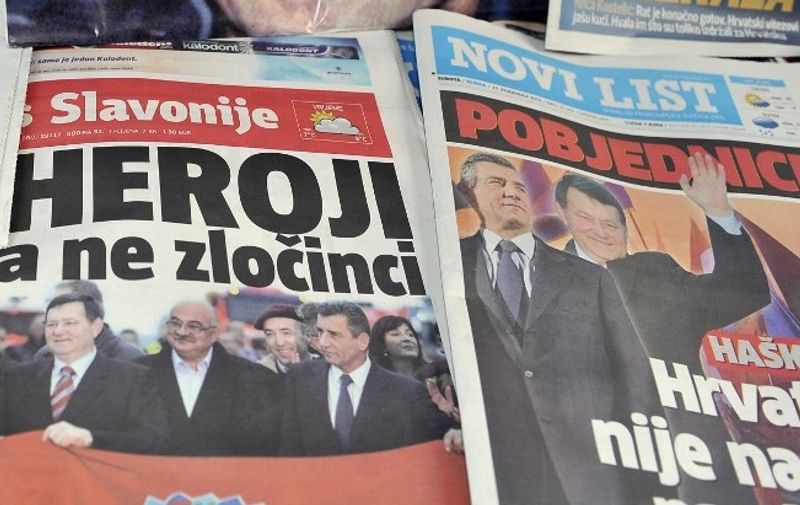 The front pages of the main Croatian daily newspapers baring pictures of former Croatian generals Ante Gotovina and  Mladen Markac are displayed on November 17, 2012 in Zagreb a day after their return to Croatia after they were freed by the UN war crimes tribunal, with many feeling the verdict vindicated Zagreb's role in the 1991-95 war against Belgrade-backed rebel Serbs. The court cleared them of committing crimes against Croatian Serbs during the bloody break-up of Yugoslavia. Many here see the ruling as confirmation that they fought a justified war.      AFP PHOTO/HRVOJE POLAN (Photo by HRVOJE POLAN / AFP)