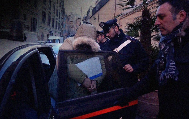 A man is taken into the Carabinieri headquarters on February 10, 2015 in Rome after being arrested during a police operation against Roman crime organisation. Italian police on Tuesday arrested 61 people after a probe established the existence of a criminal organisation linked to the Neapolitan Camorra mafia operating in the southeast of the capital. Police seized 10 million euros in assets in the operation, which they said had dismantled the organisation.  AFP PHOTO / FILIPPO MONTEFORTE (Photo by FILIPPO MONTEFORTE / AFP)