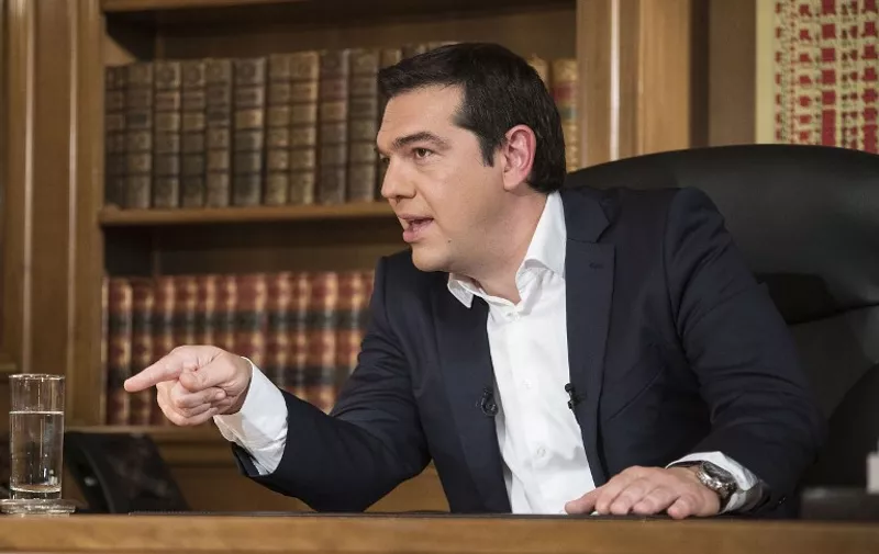 A handout photo made available by the Prime minister's office shows Greece's Prime Minister Alexis Tsipras during his interview for ERT state television on July 14, 2015.  Tsipras said he took responsibility for a hardline deal clinched with the eurozone to save the near-insolvent country, despite not believing in many of the draconian reforms it demands. "I assume responsibility for all mistakes I may have made, I assume responsibility for a text I do not believe in, but which I signed to avoid disaster for the country, the collapse of the banks," he said in an interview on Greece's public television on the eve of a key parliament vote on the reforms.  AFP PHOTO/HO/PRIME MINISTER OFFICE/ANDREA BONETTI

==RESTRICTED TO EDITORIAL USE - MANDATORY CREDIT "AFP PHOTO /HO/PRIME MINISTER OFFICE/ANDREA BONETTI " - NO MARKETING NO ADVERTISING CAMPAIGNS - DISTRIBUTED AS A SERVICE TO CLIENT - AFP IS NOT RESPONSIBLE FOR ANY DIGITAL ALTERATIONS TO THE PICTURE'S EDITORIAL CONTENT, DATE AND LOCATION ==