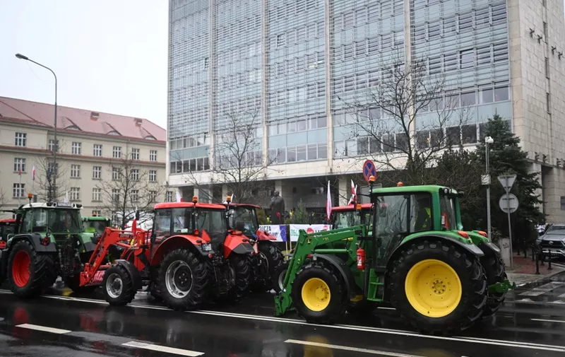 Farmers with tractors are seen in front of a government building after they entered the city center of Poznan during a protest across Poland on February 9, 2024. (Photo by Sergei GAPON / AFP)