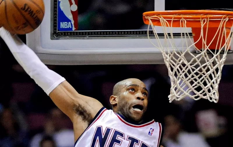 FILE- New Jersey Nets' Vince Carter goes up for a dunk during the third quarter of an NBA basketball game against the New York Knicks Sunday, March 8, 2009 in East Rutherford, N.J. The Brooklyn Nets are retiring the No. 15 jersey of Carter, the high-flying guard who will be enshrined this year in the Naismith Memorial Basketball Hall of Fame, the team announced Wednesday, May 15, 2024. (AP Photo/Bill Kostroun, File)