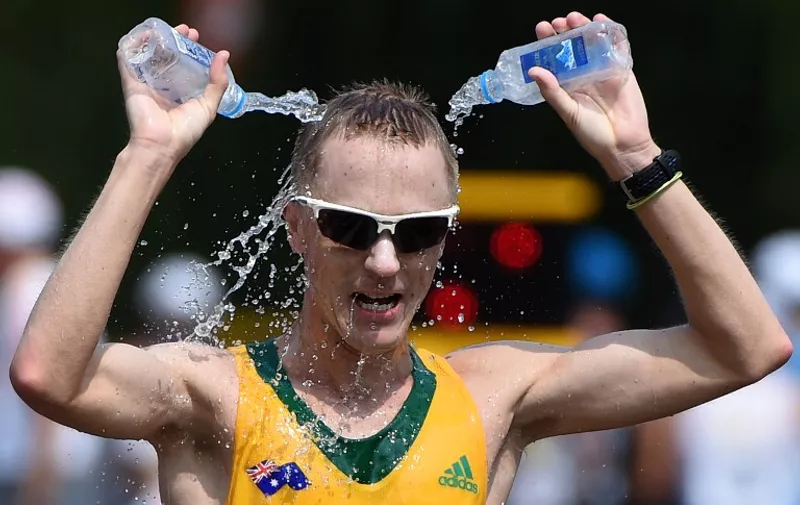 Australia's Jared Tallent pours water on his head in the final of the men's 50 kilometres race walk athletics event at the 2015 IAAF World Championships at the "Bird's Nest" National Stadium in Beijing on August 29, 2015.  AFP PHOTO / WANG ZHAO