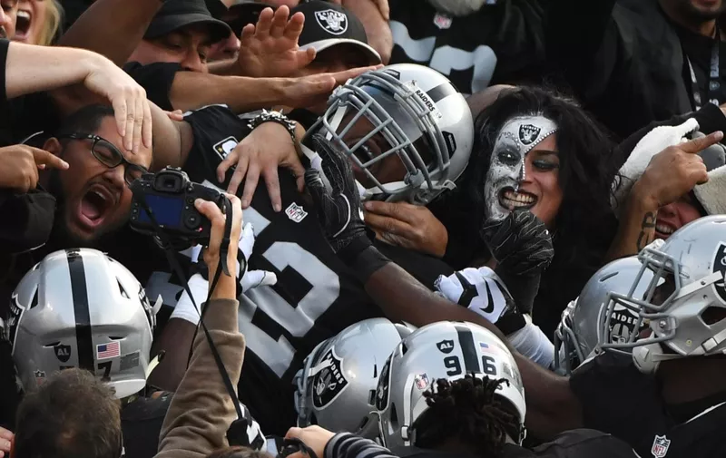 Oakland Raiders defensive end Khalil Mack (52) is mobbed in the stands after intercepting a pass by Carolina Panthers QB Cam Newton and scoring in the second quarter at the Oakland Alameda County Coliseum in Oakland, California, on November 27, 2016. The Raiders defeated the Panthers 35-32. Photo by /UPI, Image: 306879866, License: Rights-managed, Restrictions: [&hellip;]