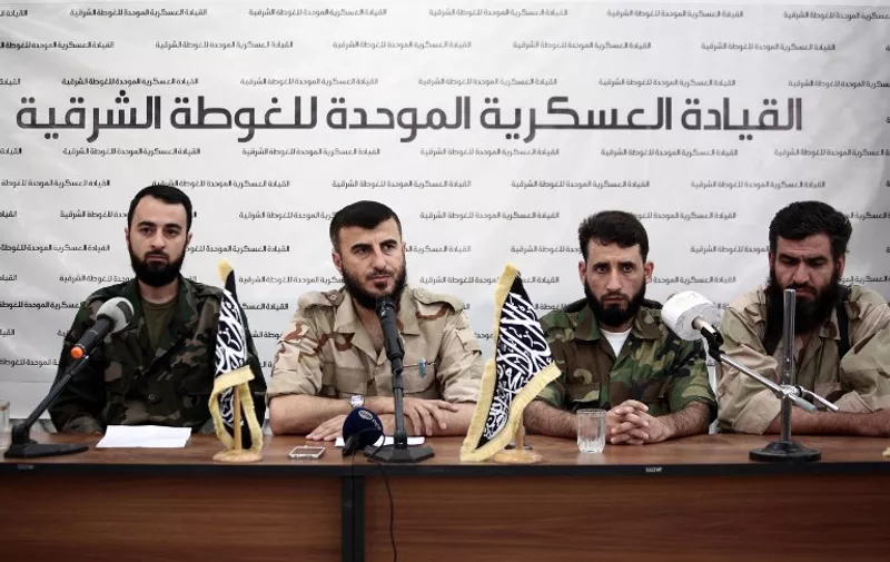 (L to R) Abu Muhammad al-Fatih, leader of Ajnad al-Sham (Soldiers of the Levant), Zahran Alloush, the leader of Jaysh al-Islam (Islam Army) and military leader of the Islamic Front, Abed al-Naser Shmer, the leader of Rahman brigade, and Abu Suleiman, the leader of Ahrar ash-Sham brigade, attend a press conference in the rebel-held Eastern Ghouta region outside the capital Damascus on August 27, 2014, to announce the fomation of "The Unified Military Command of Eastern Ghouta". The unified command consists of Ajnad al-Sham (Soldiers of the Levant), the Islam army, Ahrar ash-Sham and Rahman brigade. AFP PHOTO/ABD DOUMANY