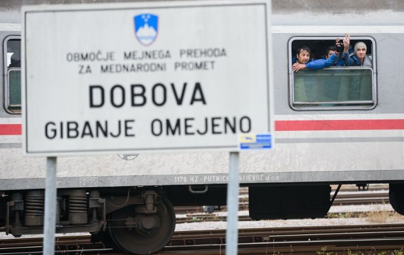 Migrants and refugees wait on a train after crossing the Croatian-Slovenian border in Dobova on October 27, 2015. More than 700,000 refugees and migrants have reached Europe's Mediterranean shores so far this year, amid the continent's worst migration crisis since World War II, the UN refugee agency said today.  AFP PHOTO / JURE MAKOVEC
