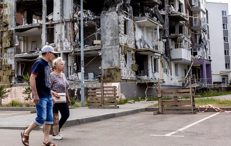People walk in front of an apartment block destroyed by bombardment in Bucha, Ukraine on June 14, 2022.  As the Russian Federation invaded Ukraine more than 3 and a half months ago, fierce fighting continues in the East of the country. Some of the most devastated towns since the beginning of the conflict - Irpin and Bucha - build their way to normality. More and more civilians get back to their homes and reestablish their lives.
Life In Bucha Amid Devastation, Ukraine - 14 Jun 2022,Image: 699763724, License: Rights-managed, Restrictions: , Model Release: no, Credit line: Profimedia