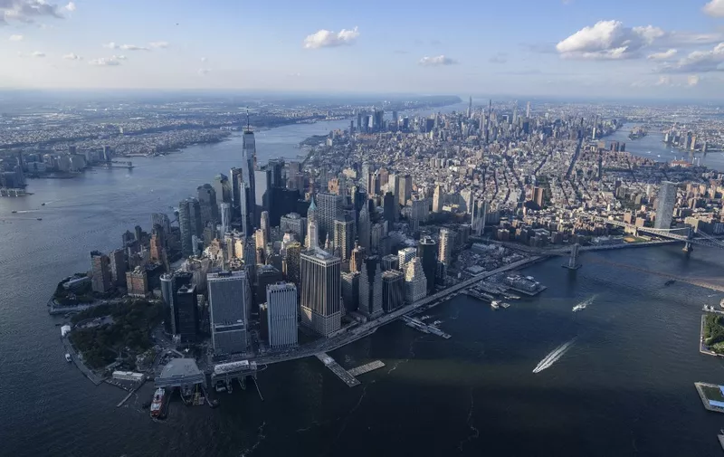 An aerial view shows the skyline of lower Manhattan, New York city on August 5, 2021. (Photo by Ed JONES / AFP)