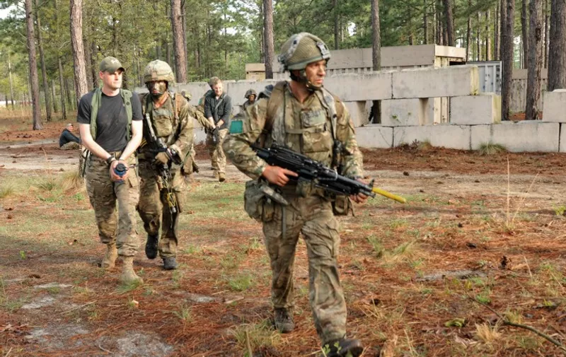 In this April 18, 2015 US Army handout photo, paratroopers from the British 16 Air assault Brigade, escorting captured high value targets during Combined Joint Operational Access Exercise (CJOAX) at Fort Bragg, North Carolina. In the largest bilateral training operation occurring on Fort Bragg in the last 20 years, more than 3,000 Soldiers from the US and UK participated in the exercise. AFP PHOTO / HANDOUT / US ARMRY / SGT. ELIVERTO V. LARIOS        == RESTRICTED TO EDITORIAL USE / MANDATORY CREDIT: "AFP PHOTO / HANDOUT / US ARMY / SGT. ELIVERTO V. LARIOS  "/ NO MARKETING / NO ADVERTISING CAMPAIGNS / NO A LA CARTE SALES / DISTRIBUTED AS A SERVICE TO CLIENTS ==