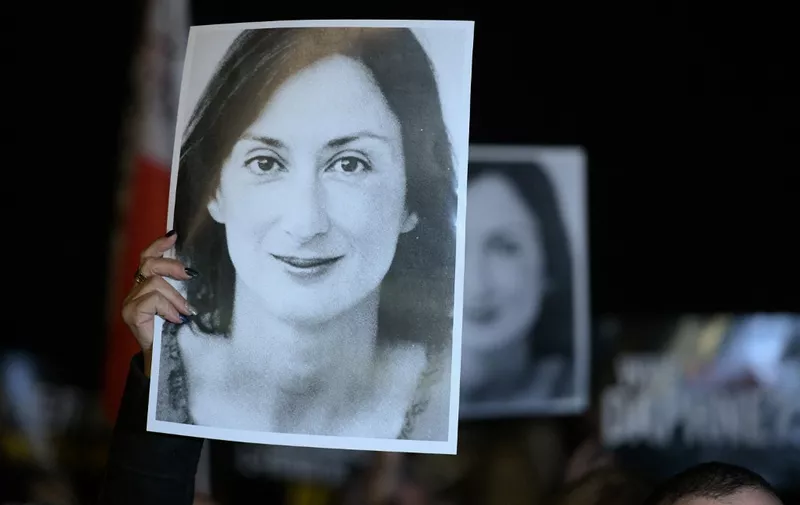 Protesters hold pictures of the late journalist Daphne Caruana Galizia as they gather outside the prime minister's office to call for his resignation, in Valletta, Malta on November 20, 2019, the day Maltese businessman Yorgen Fenech, who is believed to be the mastermind behind her assassination, was detained on his yacht after he tried to leave Malta. - Malta on November 20 arrested a tycoon in connection with the murder of journalist Daphne Caruana Galizia, the day after an alleged middleman was offered a pardon to identify the mastermind behind the killing. Maltese national Yorgen Fenech was detained on his yacht at dawn as he tried to leave Malta, in the latest development in the long-running case that has raised questions about the rule of law in Malta. (Photo by Matthew Mirabelli / AFP)