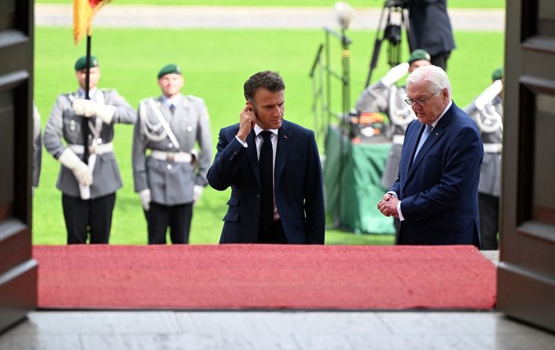 French President Emmanuel Macron is welcomed by German President Frank-Walter Steinmeier with military honours at Bellevue presidential palace in Berlin, Germany on May 26, 2024. The French president pays a three-day state visit to Germany until May 28. (Photo by RALF HIRSCHBERGER / AFP)