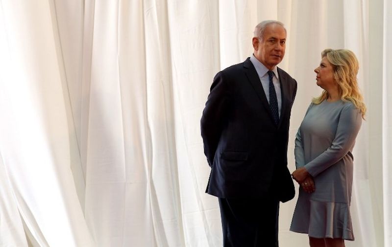 (FILES) In this file photo taken on June 6, 2017 Israeli Prime Minister Benjamin Netanyahu (L) and his wife Sara wait for the arrival of Ethiopian Prime Minister and his wife ahead of a welcoming ceremony at the PM's office in Jerusalem.
Sara Netanyahu was charged with fraud and breach of trust on June 21, 2018 after a long police probe into allegations she falsified household expenses, the justice ministry said. / AFP PHOTO / Gali TIBBON